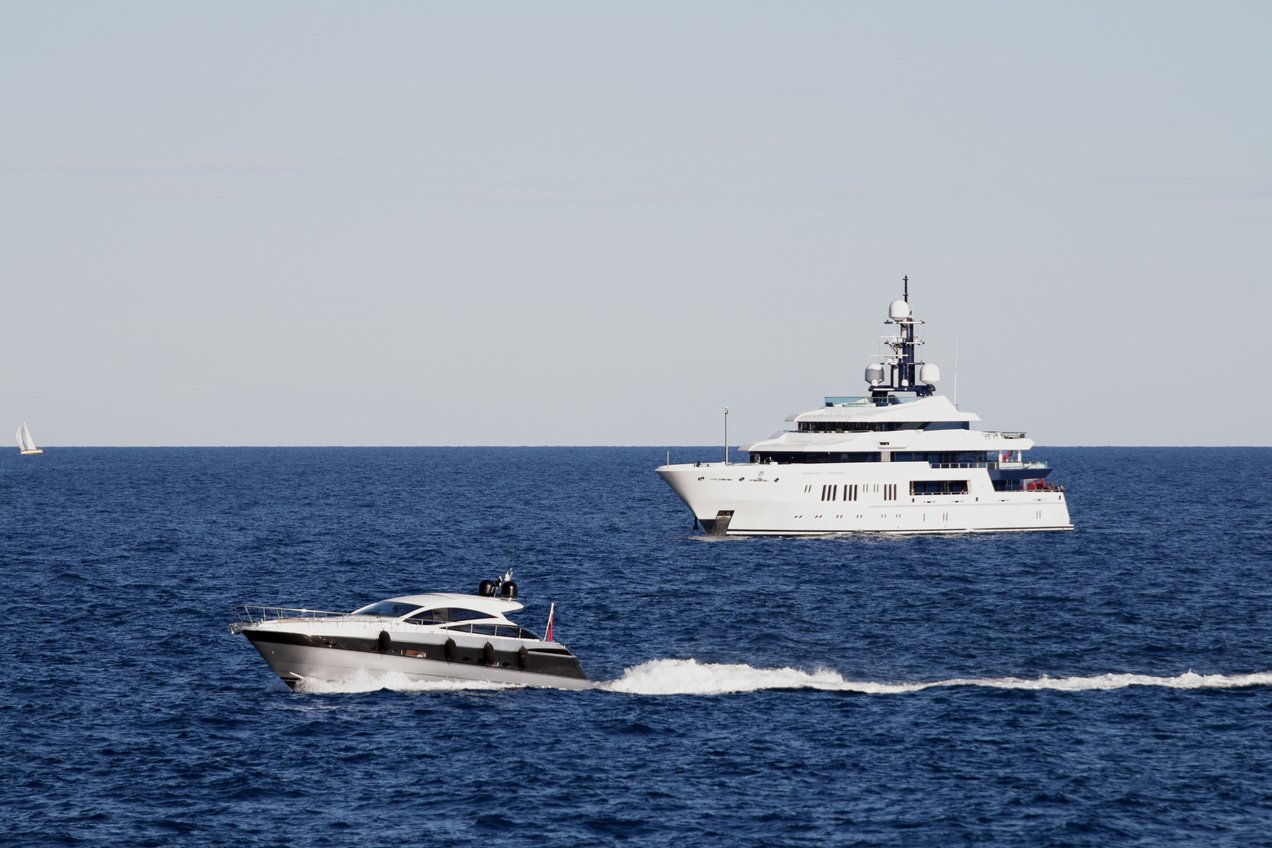 Superyacht and smaller motor yacht